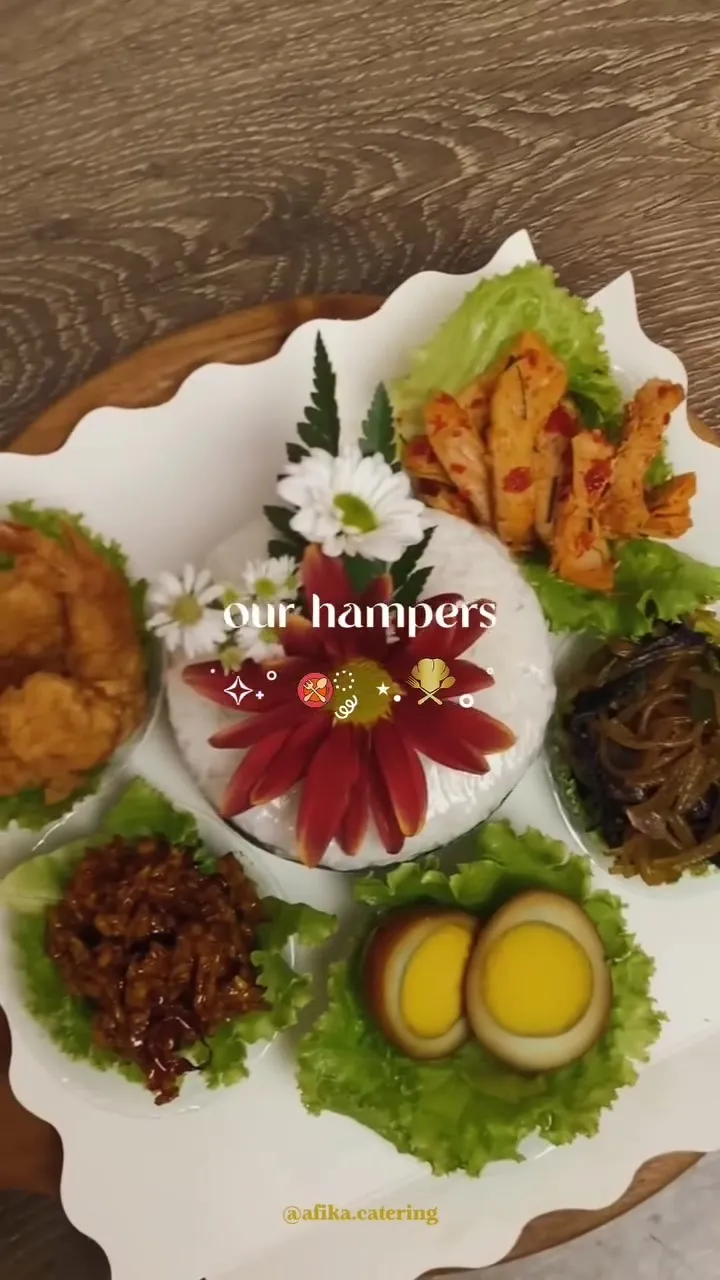 Hampers Afika Catering berisi aneka lauk di atas piring saji berhias bunga