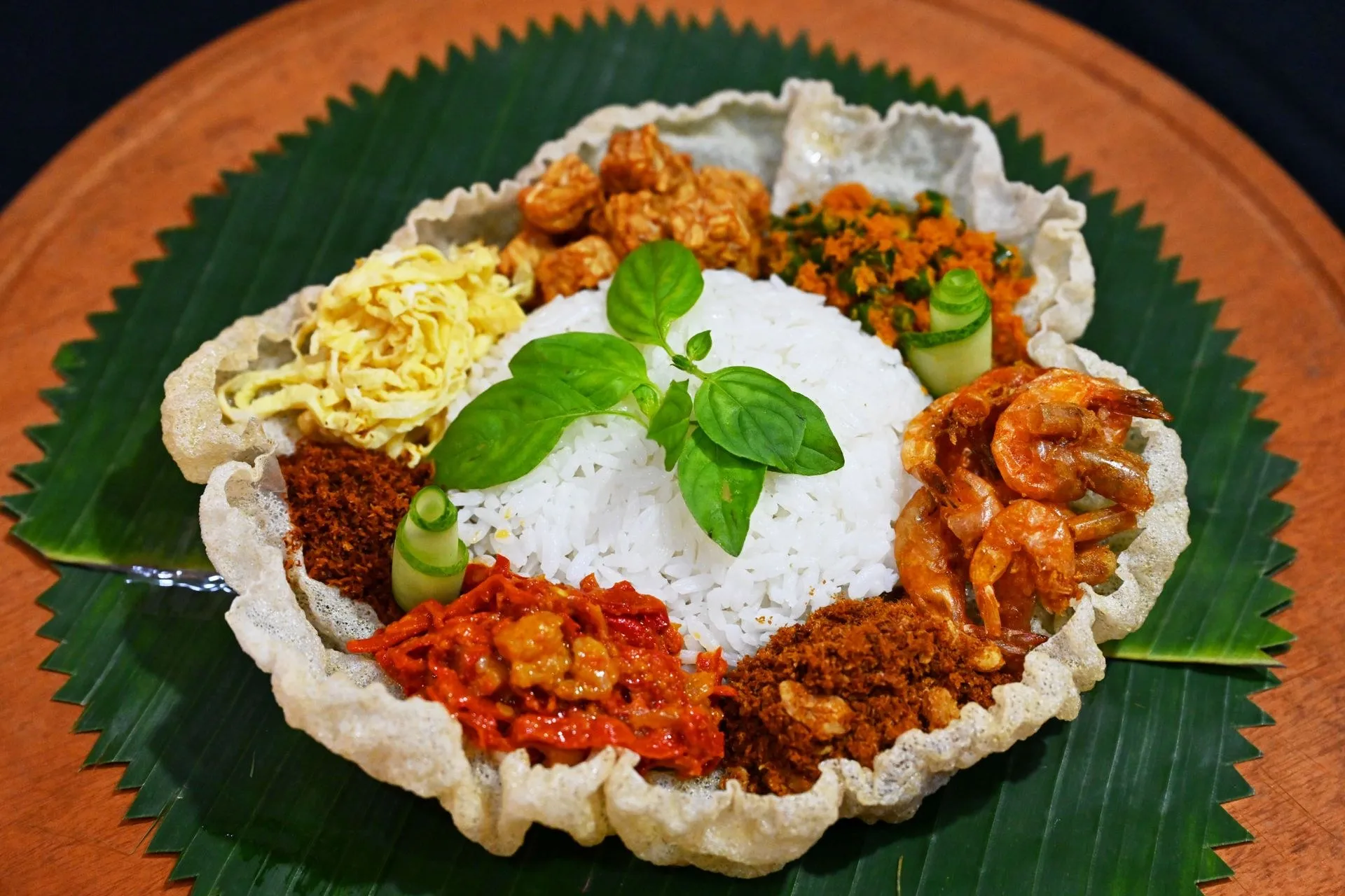 Nasi dengan aneka lauk di atas daun pisang